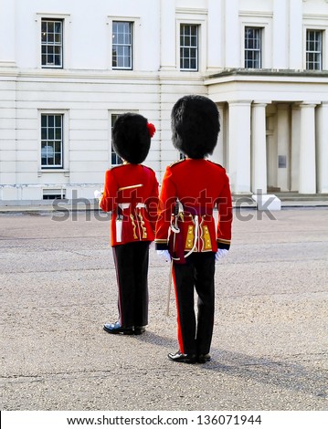 Two guards in red coat