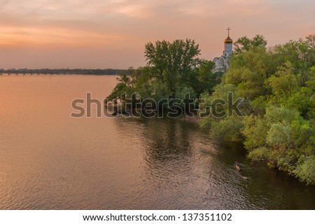 Landscape with an Orthodox church in sunset rays - Dnepropetrovsk city, Ukraine.