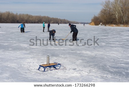 Dnepropetrovsk, Ukraine - January 26, 2014: During cold weather people use frozen river Dnepr for to go in for skating.