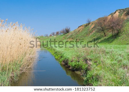 Landscape with small Ukrainian river Sura at early spring season