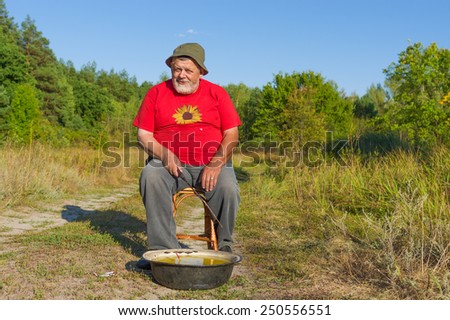 Portrait of an old man with handmade fishing kit