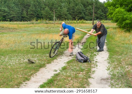 Senior man punishing bicycle thief with club in Ukrainian rural area