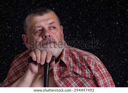 Portrait of senior man dreaming against star sky