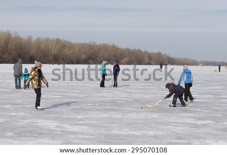 Dnepropetrovsk, Ukraine - January 26, 2014: People in the city use frozen river Dnepr for to go in for skating