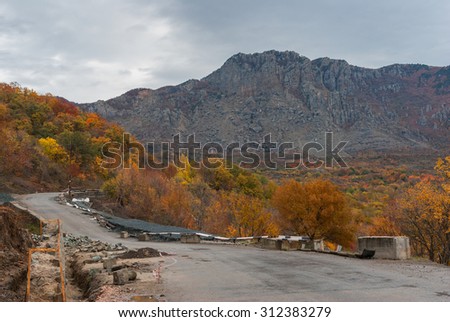 Autumnal landscape with road maintenance in Crimean mountains