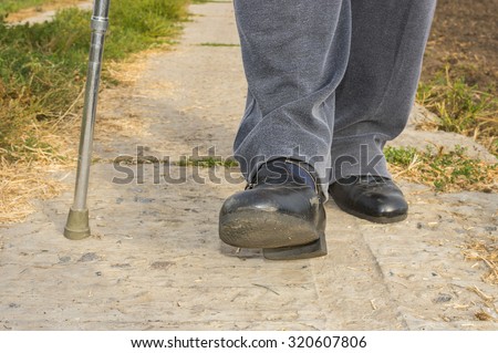 Man with walking stick doing hard step outdoor