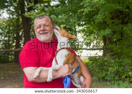 Senior man is happy when his pet shows affection