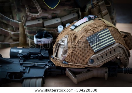 military equipment with a rifle on a wooden table