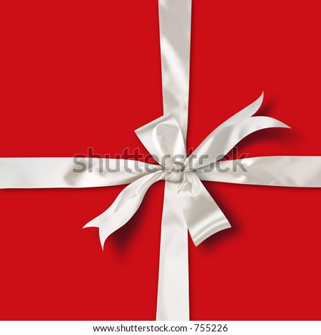 White satin ribbon over red paper gift box