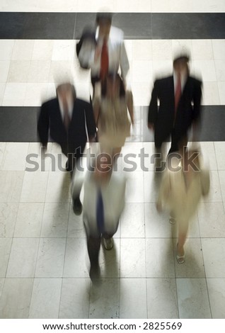 Business people going to work walking through a marble corridor