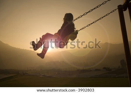 Girl on Swing in a country club at sunset