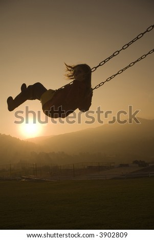 Girl on Swing in a country club at sunset