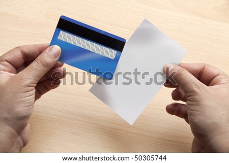 Closeup of hands holding a blank credit card and receipt ready to add any data