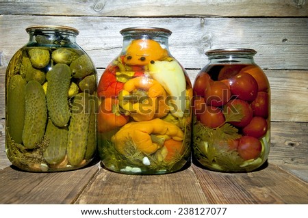 Preserved  vegetables on wooden background.Marinated food.