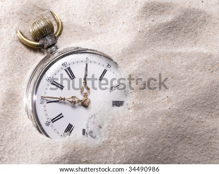 Pocket watch in sand