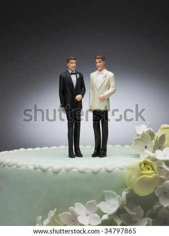 stock photo Two groom figurines on top of wedding cake
