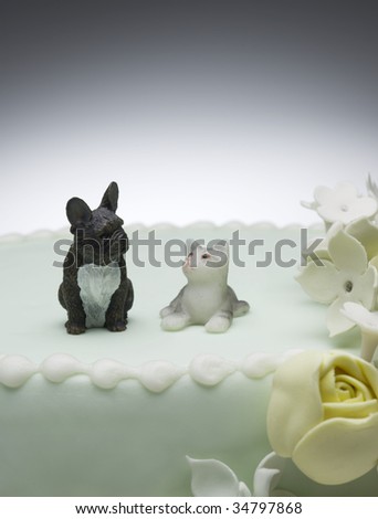 stock photo Dog and cat figurines on top of wedding cake