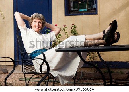 A recently retired lady relaxing, enjoying life and taking it easy