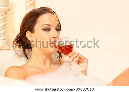 Sad lady drinking in the bath