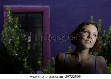 Beautiful woman against purple building