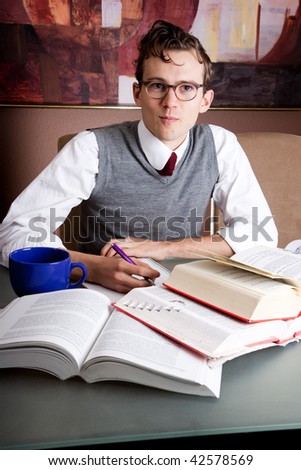 Handsome student studies hard for exams