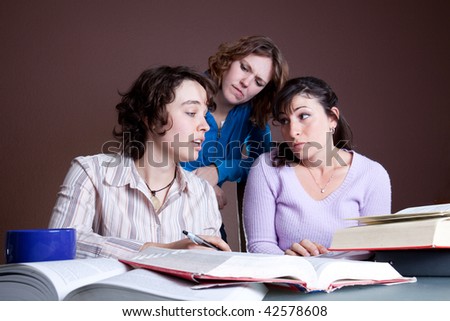 Three ladies studying hard for exams