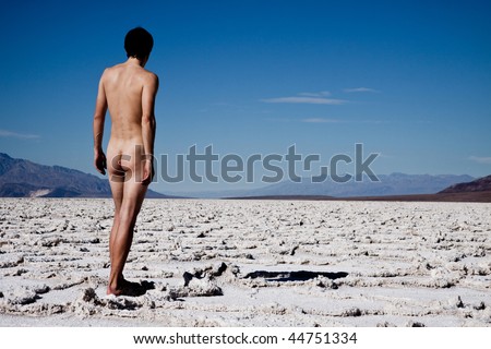 Nude man walks alone in the heat of the sun