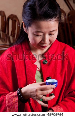 Attractive woman inside a traditional tea house, reading her tea leaves