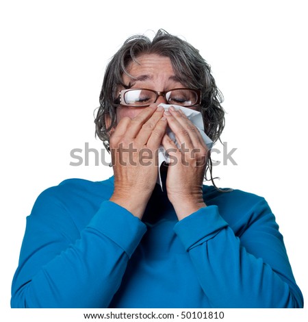 Lady sneezes, feeling unwell due to the flu
