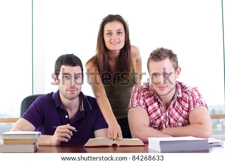 Attractive young woman teaches two young students