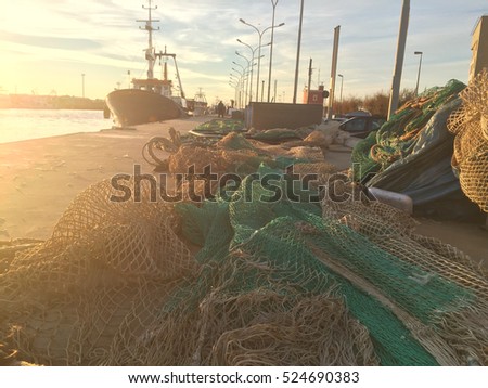 sunset with fishing nets in the harbor of Fiumicino, Rome, Italy