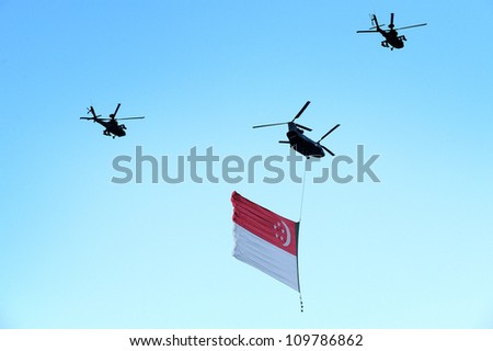 SINGAPORE - AUG 9: Chinook helicopter flying Singapore flag during Singapore National Day Parade (NDP) 2012 on Aug 9, 2012 in Singapore. The theme for NDP 2012 is  Loving Singapore, Our Home.