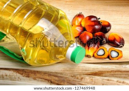 Close up of fresh Palm Oil seeds and cooking oil