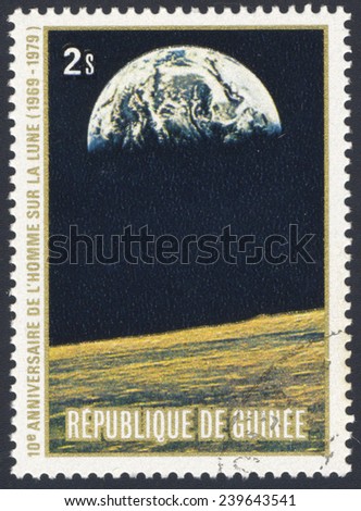 REPUBLIC OF GUINEA - CIRCA 1979: A stamp printed in the Republic of Guinea shows the Apollo 11 Moon Landing and first step on The Moon surface - view of Earth, circa 1979