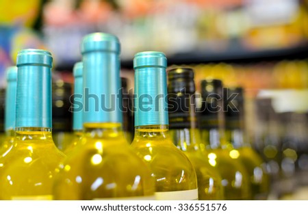 Bottles of wine in rows in liquor store, selective focus.