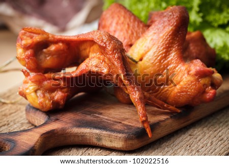 Smoked delicious chicken wings on the hardboard