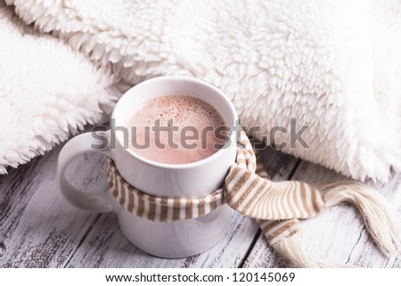 Warming drink - cup of cocoa with milk on the table