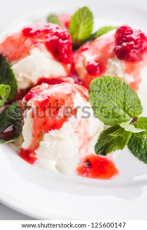 Vanill ice cream with strawberry jam and mint leaves
