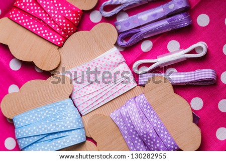 Polka dot ribbon on wooden vintage bobbins for scrapbooking
