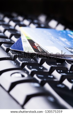 E-commerce, shopping on the internet, different credit cards on the keyboard