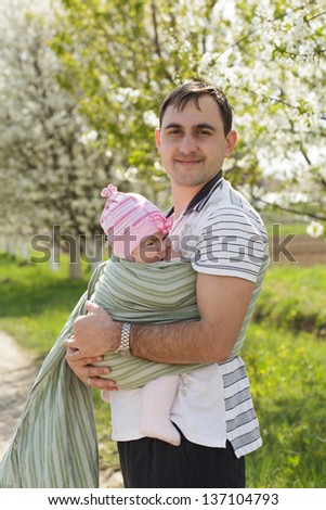Young father with his five months baby outdoor