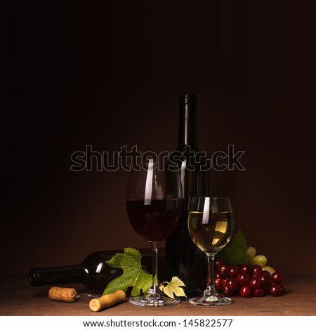 Wine still life: bottles, corks, grapes and glasses
