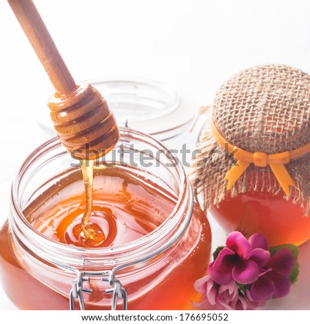 Honey drip and jar on white backround