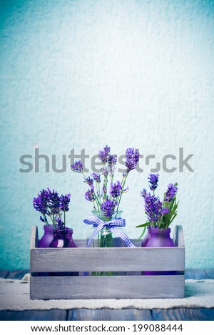 Lavender in bottles, decor provance style, wooden box on crochet tablecloth