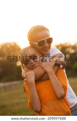 Two teenage girls have fun in the park. Two friends outdoor. Summwer people in glasses