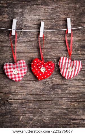 White and red sewed christmas hearts attached to the rope. Holiday background for greetings Valentine's  day