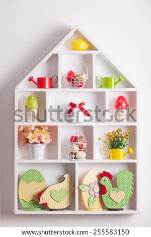 House shelves on a wall - Easter decorations for holiday