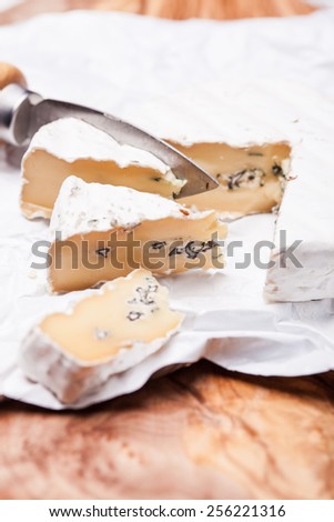 Soft cheese containing veins of blue mold and a firm white skin. Two types of mold in cheese duet