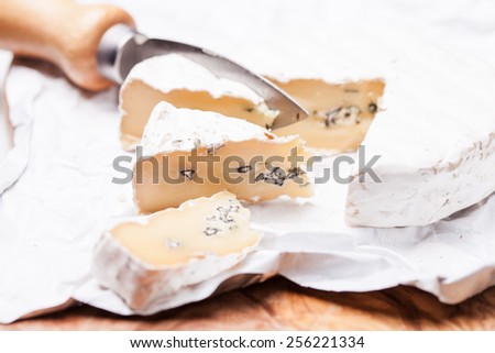 Soft cheese containing veins of blue mold and a firm white skin. Two types of mold in cheese duet