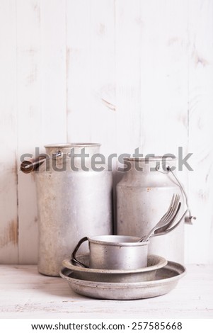 Old aluminium utensils on the shabby chic kitchen